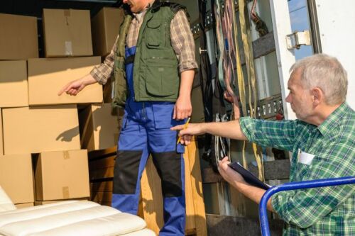 Two men loading a moving truck