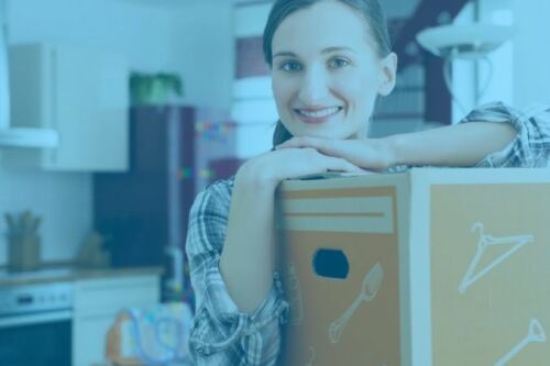 Woman smiling with a packed box