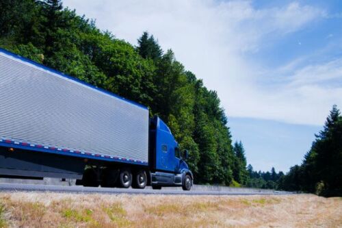 Truck driving down a road