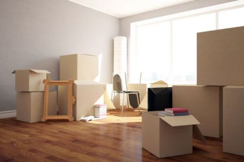 Boxes packed and stacked in a room for moving and shipping