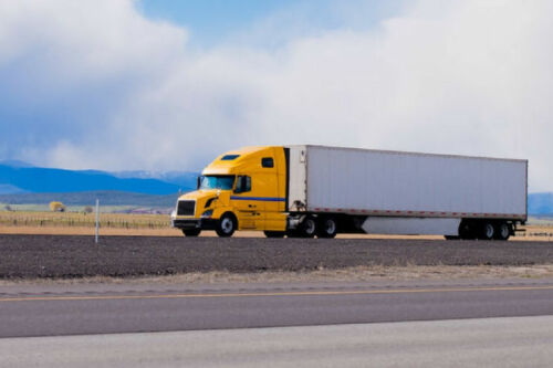 A truck driving down the road
