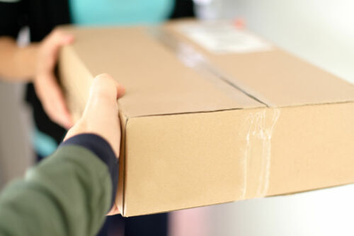 Man grabbing a package from a delivery