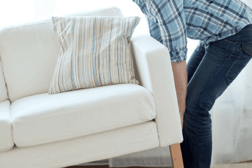Guy lifts heavy couch