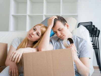 couple struggling to pack their belongings