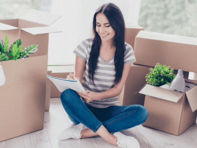 woman sitting on floor planning her move