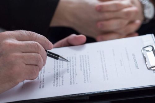 Someone signing a document for an estate sale