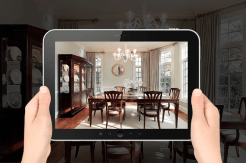 Woman holding an ipad surveying her home for a move