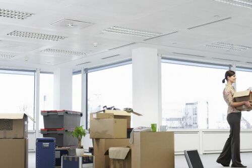 A woman packs up stuff in an office