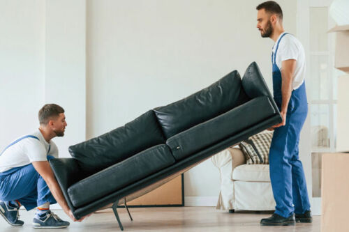 Two men moving a couch